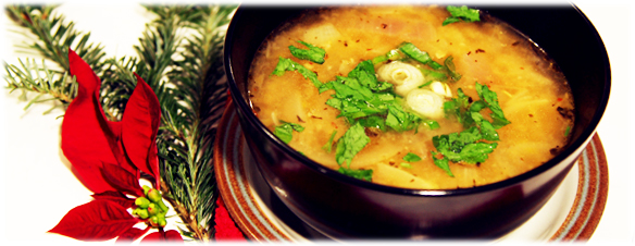 miso soup in a bowl atop poinsettia leaves