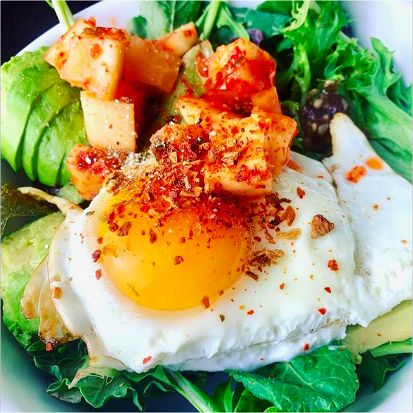 Kimchi Salad with Azuki Bean Miso Dressing, featuring a sunny-side-up egg on a plate