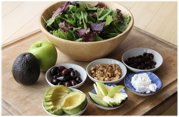 salad ingredients in bowls on a board