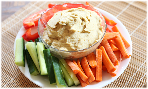 Charcuterie with hummus in a bowl on a plate