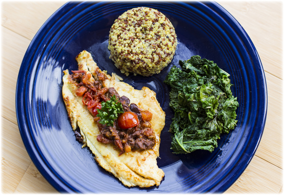 chicken, quinoa, and greens on a blue plate