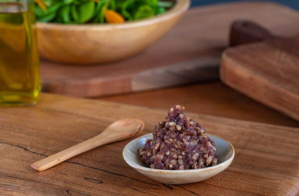 Dollop of miso in a bowl with a salad in the background