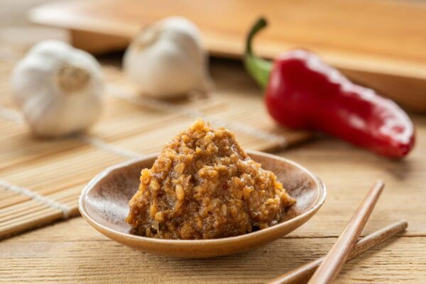 Close-up of a dollop of miso with garlic and a red pepper