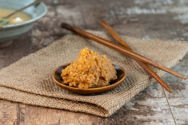 Dollop of miso in a bowl with chopsticks