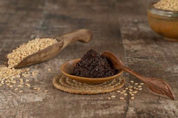 Dollop of miso with a scoop of barley in the background