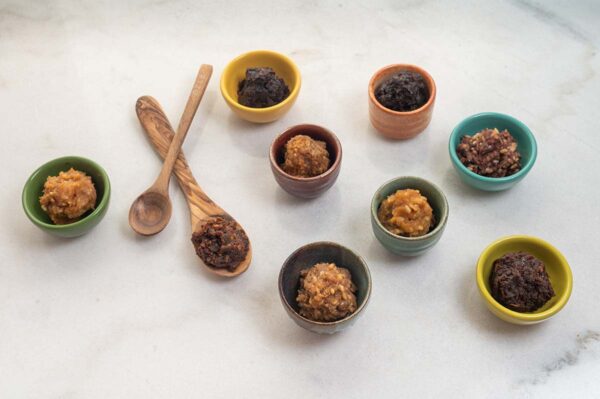 Nine dollops of miso in colorful bowls